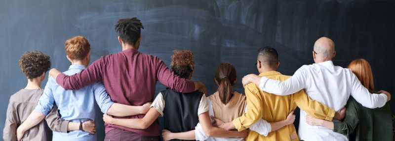 Group of people facing chalkboard