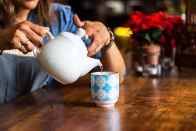 photo of individual pouring water into a cup.