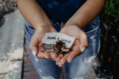 photo of individual with coins in their hands.