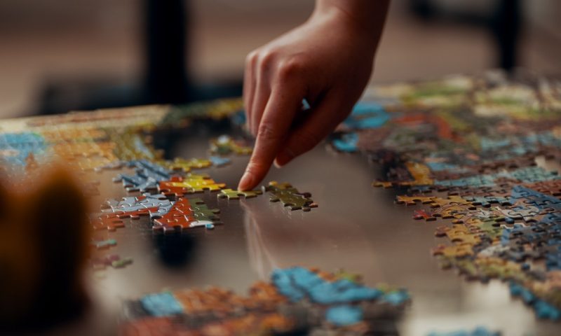person completing a puzzle
